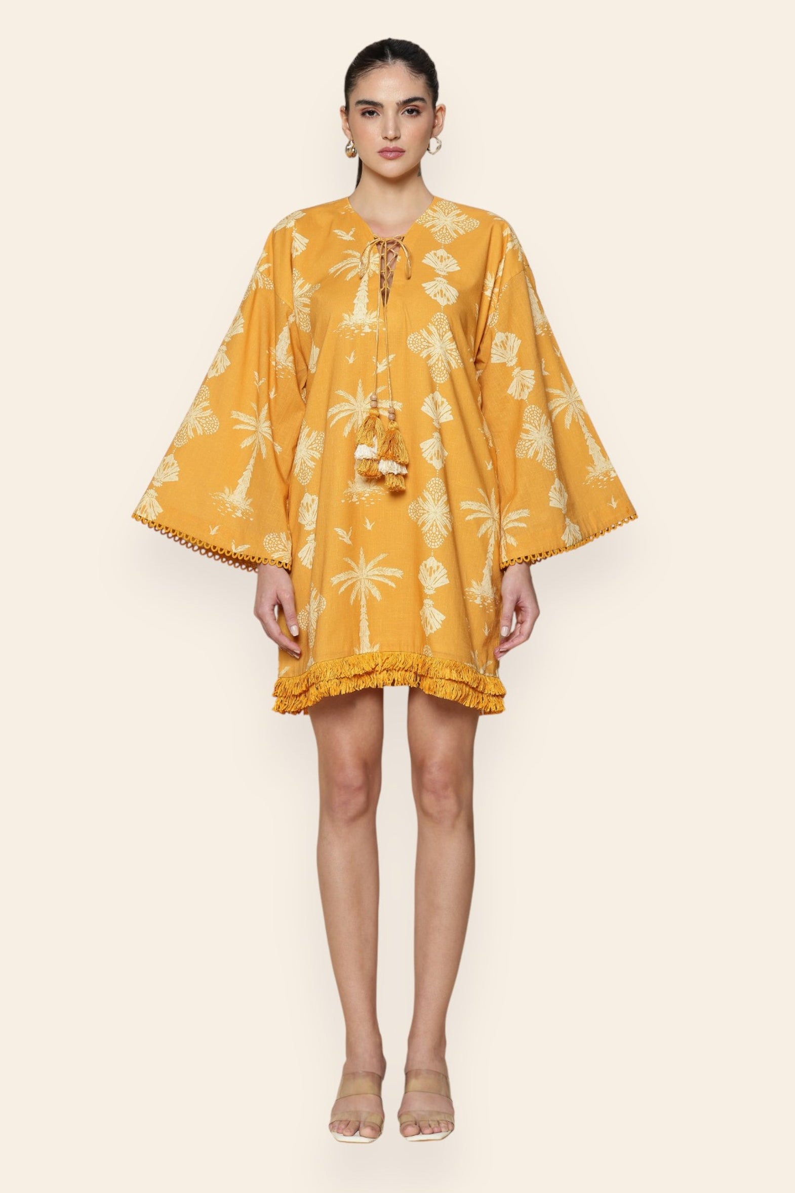 Woman wearing a yellow floral dress on a white background